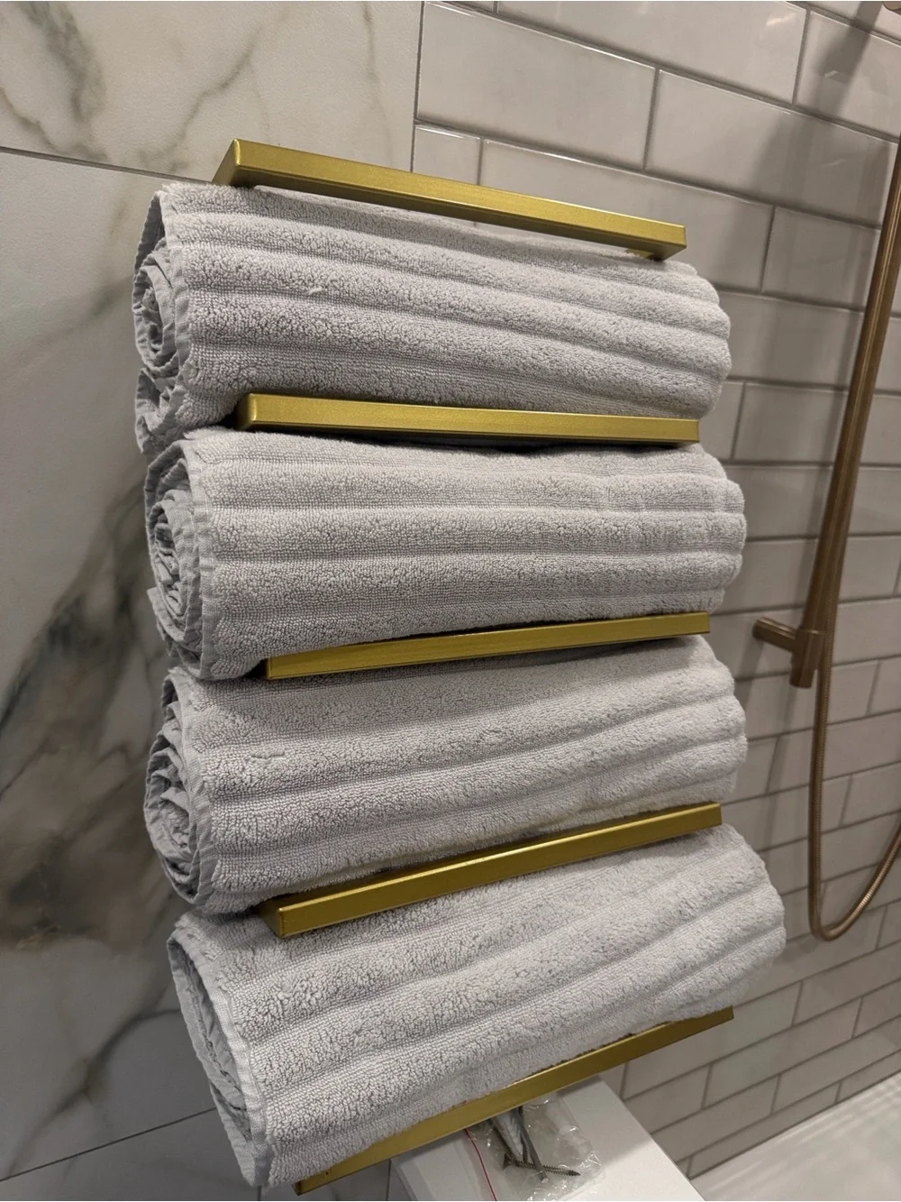 Gold Wall-Mounted Towel Rack with Green and Beige Towels - Modern Bath Storage